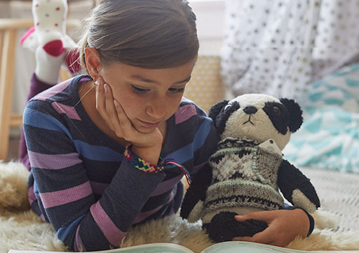 Girl with stuffed animal with Tile on it